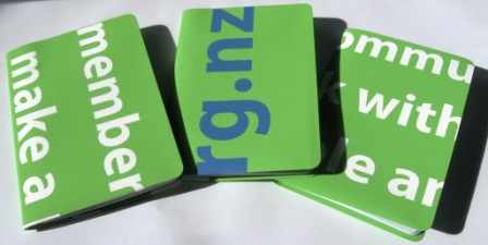 Recycled notebooks made from outdated pull up plasticized paper banners.